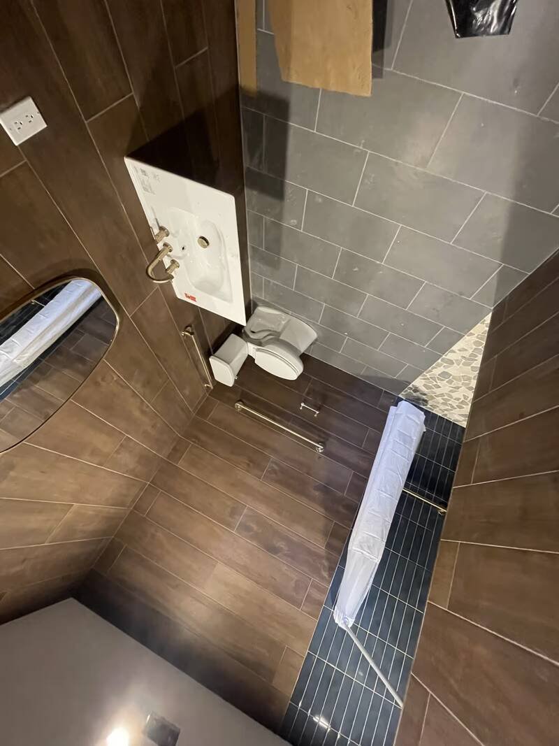 Bathroom with a newly installed wall-mounted sink and toilet