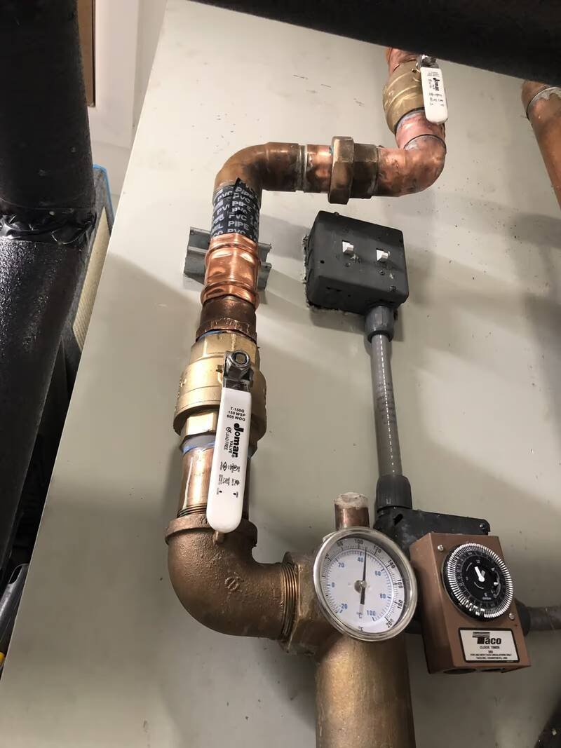 New copper piping and ball valves at a hot water recirculation pump and timer
